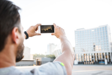 Fototapeta premium Back view photo of strong mature sportsman