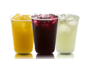 Lemon, Orange and grape juice with ice inside a few plastics on white background