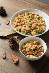 Fried rice with egg and wood grain background