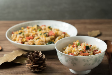 Fried rice with egg and wood grain background