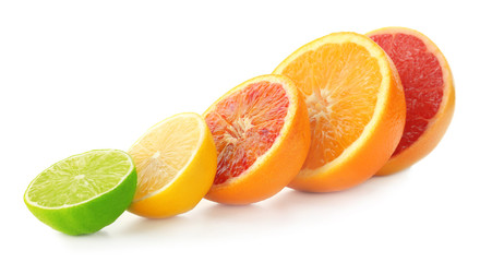 Tasty cut citrus fruits on white background