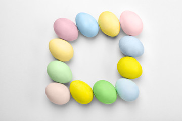 Composition with dyed Easter eggs on light background