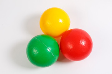 educational kids colored plastic balls toys on white background.