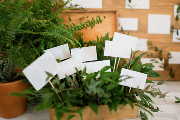 Stylish table list seating plan for wedding reception, greenery style.