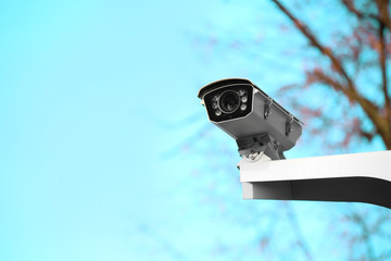 Modern CCTV camera on street post outdoors