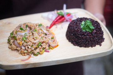 Thai style chicken salad served with rice berry