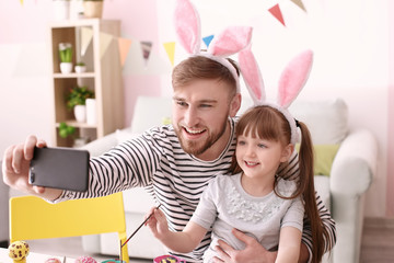 Father taking selfie with his daughter on Easter
