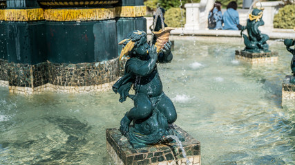 Fototapeta na wymiar Water Golden Outdoor fountain with small Angels in Baku, Azerbaijan