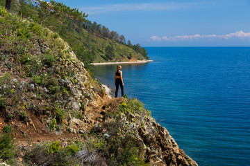 A teenage girl standing at a hill at Baikal lake