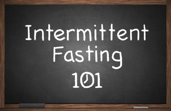 Intermittent fasting 101 with clock drawn on blackboard