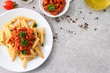 Composition with tasty penne pasta on table