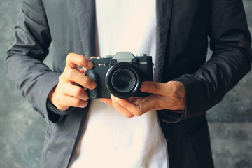 Photographer holding mirrorless camera