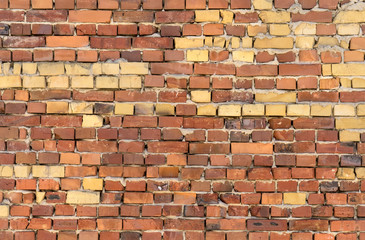 Fototapeta premium Wall with red and yellow bricks