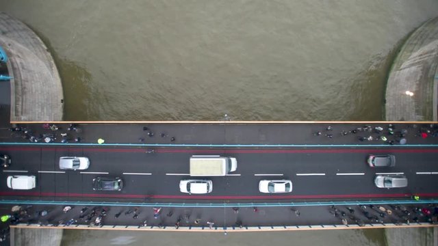 Traffic and pedestrians flow across Tower Bridge, seen through the new glass floor in the bridge's walkways. 