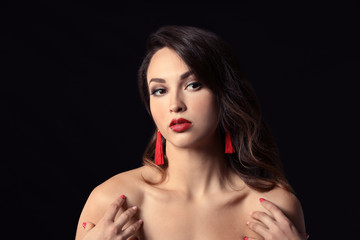 Portrait of young woman with beautiful professional makeup on dark background