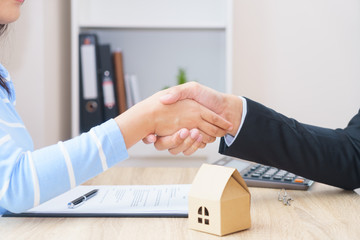 Customer or woman say yes to sign loan contract for buying new home concept - hand shaking