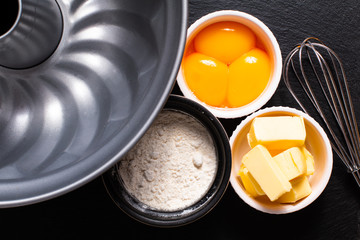 Base of Bakery preparation butter, flour, egg yolks on black slate stone