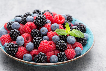 Fresh raspberries in a plate on a  vintage background.