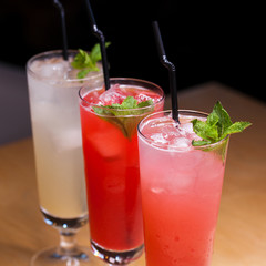 Close up three glasses of soft drink. Three different summer lemonade with mint