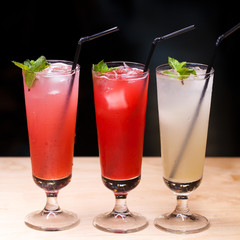 Close up three glasses of soft drink. Three different summer lemonade with mint