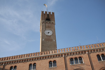 Fototapeta na wymiar Treviso, Italy - May 29, 2018: View of Palazzo del Podesta and Torre Civica.