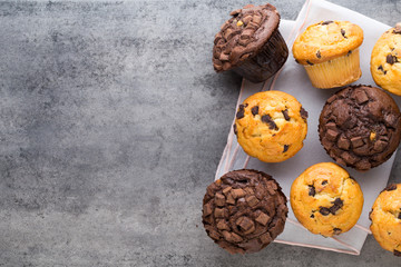 Homemade chocolate muffins on the vintage background.