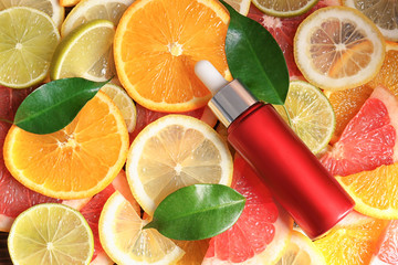 Bottle of essential oil on citrus slices