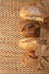 Various kind of bread put together on weave grass background with copy space.