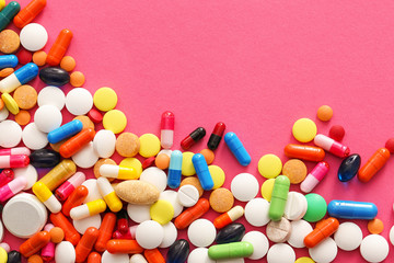 Different pills on color background