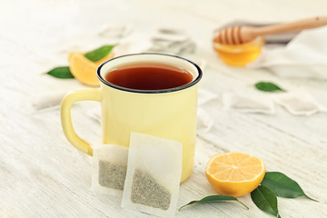 Mug with delicious tea on table