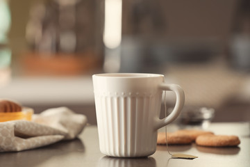 Cup with delicious tea on table