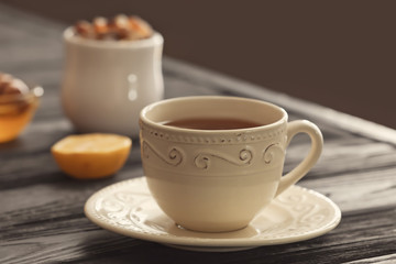 Cup with delicious tea on table