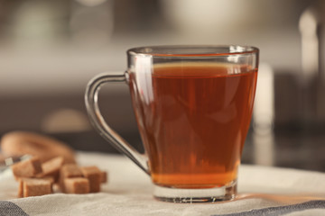 Cup with delicious tea on table