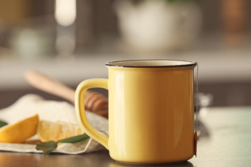 Mug with delicious tea on table