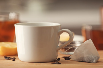 Cup with delicious tea on table