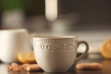 Cup with delicious tea on table