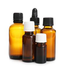 Bottles with essential oils on white background