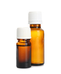 Bottles with essential oils on white background