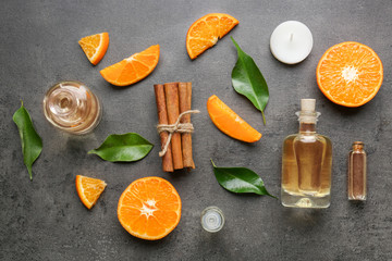 Composition with bottles of citrus essential oil on table, top view