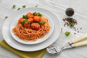 Plate with spaghetti and meatballs on table. Delicious pasta recipes