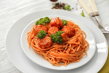 Plate with spaghetti and meatballs on table. Delicious pasta recipes