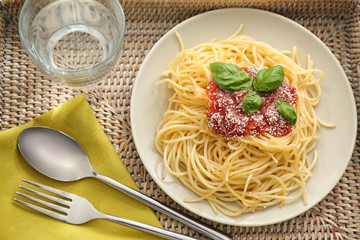 Plate with spaghetti and sauce on tray. Delicious pasta recipes