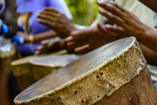 Percussionist playing a rudimentary atabaque during afro-brazilian cultural manifestation