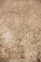 Vertical photograph of rough weathered concrete wall texture