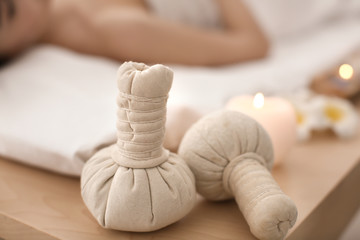 Herbal bags on table in spa salon