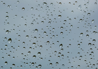 Textured water drops on the window glass.