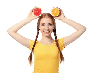 Funny young woman with citrus fruits on white background