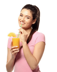 Beautiful young woman with glass of citrus juice on white background