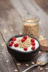 Yogurt. Stone bowl with fresh yogurt and berries on rustic table