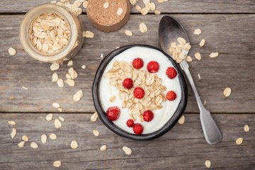 Yogurt. Stone bowl with fresh yogurt and berries on rustic table